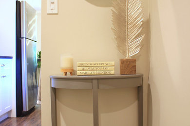 Entryway - mid-sized contemporary medium tone wood floor and brown floor entryway idea in New York with gray walls