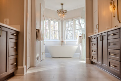 Large transitional master white tile and porcelain tile porcelain tile, beige floor and double-sink bathroom photo in Baltimore with shaker cabinets, brown cabinets, beige walls, an undermount sink, quartz countertops, a hinged shower door, white countertops, a niche and a built-in vanity