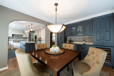 Kitchen/dining room combo - mid-sized transitional medium tone wood floor and brown floor kitchen/dining room combo idea in Minneapolis with gray walls and no fireplace