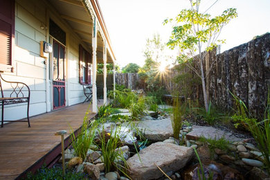 This is an example of a small front yard garden in Melbourne with with pond and decking.