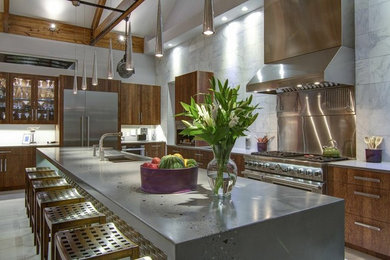 Example of a huge trendy l-shaped porcelain tile and beige floor open concept kitchen design in Tampa with an undermount sink, flat-panel cabinets, dark wood cabinets, concrete countertops, white backsplash, marble backsplash, stainless steel appliances, an island and gray countertops