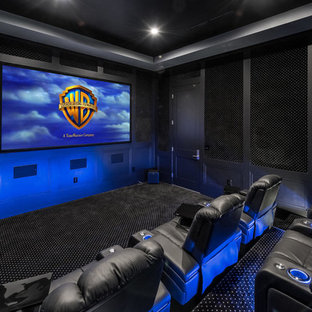 Inspiration for a traditional enclosed home cinema in Los Angeles with black walls, carpet, a projector screen and black floors.