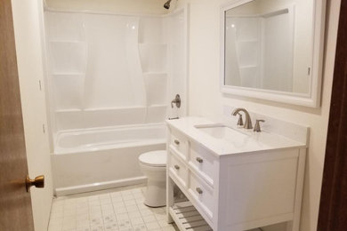 Bathroom - mid-sized modern bathroom idea in Seattle with beaded inset cabinets, white cabinets and granite countertops