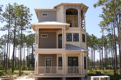 Example of a large beach style gray three-story mixed siding gable roof design in Miami