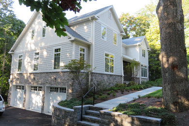 Inspiration for a large craftsman three-story concrete fiberboard gable roof remodel in New York