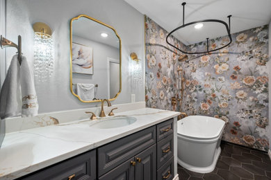 Inspiration for a master porcelain tile porcelain tile, gray floor and single-sink bathroom remodel in Dallas with raised-panel cabinets, gray cabinets, a one-piece toilet, multicolored walls, an undermount sink, quartz countertops and white countertops