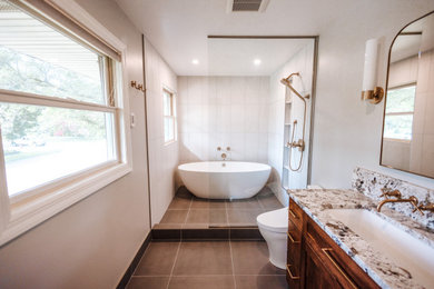 Bathroom - mid-sized traditional master ceramic tile, gray floor and double-sink bathroom idea in Other with recessed-panel cabinets, dark wood cabinets, a built-in vanity, a one-piece toilet, beige walls and a trough sink