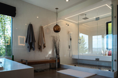 Inspiration for a large modern master white tile and porcelain tile porcelain tile and gray floor corner shower remodel in Los Angeles with glass-front cabinets, gray cabinets, an undermount tub, a one-piece toilet, white walls, an undermount sink, quartz countertops, a hinged shower door and white countertops