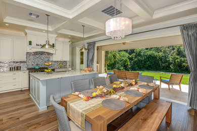 Design ideas for a mid-sized transitional open plan dining in Tampa with blue walls and light hardwood floors.