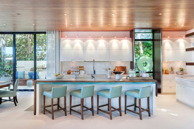 Inspiration for a contemporary eat-in kitchen remodel in Miami with flat-panel cabinets, white cabinets, white backsplash and an island