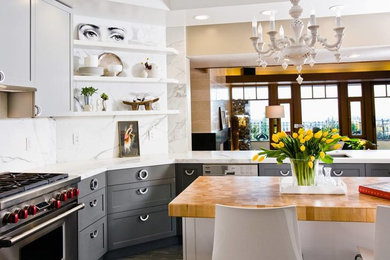 Example of a mid-sized eclectic l-shaped porcelain tile enclosed kitchen design in San Francisco with an undermount sink, shaker cabinets, gray cabinets, marble countertops, white backsplash, stone slab backsplash, stainless steel appliances and an island