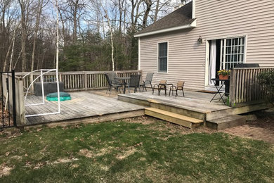 Mid-sized elegant backyard deck photo in Manchester with no cover
