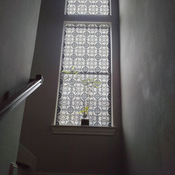Stair landing with double-height window in Delia Shades' "Portuguese Tile" - Roller Shades