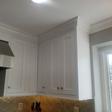 crown molding stacked to the ceiling continues over the window