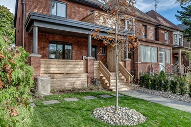 Modern two-story brick house exterior idea in Toronto with a shingle roof