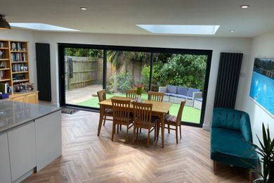 This is an example of a medium sized modern living room in Sussex with white walls.