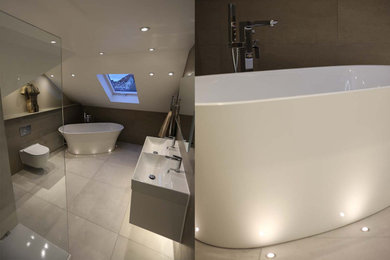 Design ideas for a contemporary kids bathroom in Hertfordshire with white cabinets, a freestanding tub, an open shower, a wall-mount toilet, gray tile, porcelain tile, grey walls, porcelain floors, a wall-mount sink, grey floor, an open shower, a double vanity and a floating vanity.