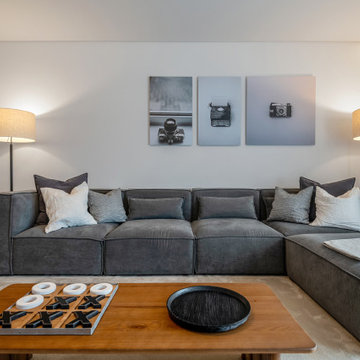 Media room with game table and grey sectional sofa, Alfragide