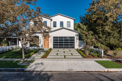 Huge minimalist two-story board and batten house exterior photo in Los Angeles with a metal roof