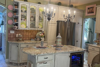 Example of a mid-sized cottage chic l-shaped brick floor and beige floor enclosed kitchen design in Philadelphia with a single-bowl sink, beaded inset cabinets, distressed cabinets, granite countertops, multicolored backsplash, ceramic backsplash, stainless steel appliances, an island and beige countertops