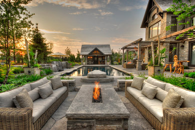 Inspiration for a craftsman backyard stone patio remodel in Toronto
