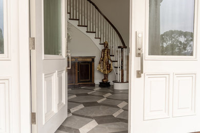 Inspiration for a large contemporary porcelain tile and gray floor entryway remodel in San Francisco with gray walls and a white front door