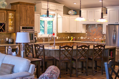 Open concept kitchen - large transitional l-shaped medium tone wood floor open concept kitchen idea in Other with an undermount sink, flat-panel cabinets, medium tone wood cabinets, quartzite countertops, brown backsplash, ceramic backsplash, stainless steel appliances and an island