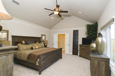 Inspiration for a mid-sized transitional master carpeted bedroom remodel in Austin with beige walls