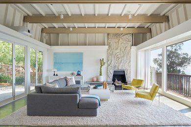 This is an example of a midcentury open concept living room in San Francisco with white walls and a standard fireplace.