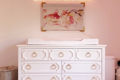 Inspiration for a mid-sized transitional girl medium tone wood floor and brown floor kids' room remodel in New York with beige walls