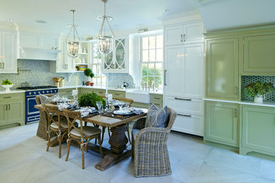 This is an example of a traditional kitchen in Philadelphia with white cabinets and blue splashback.