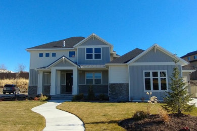 Example of a large arts and crafts gray three-story concrete fiberboard exterior home design in Salt Lake City with a mixed material roof