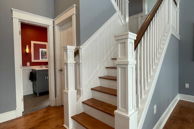 Example of a classic wooden wood railing staircase design in New York with wooden risers