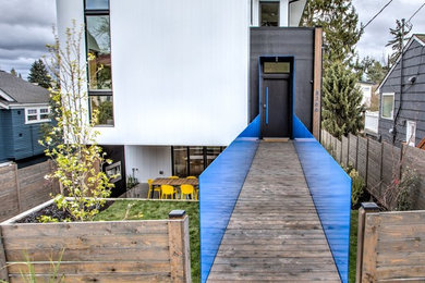 Large contemporary white three-story metal exterior home idea in Seattle