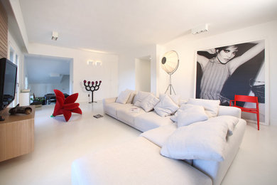 На фото: большая парадная, изолированная гостиная комната в современном стиле с белыми стенами, бетонным полом, телевизором на стене и белым полом без камина