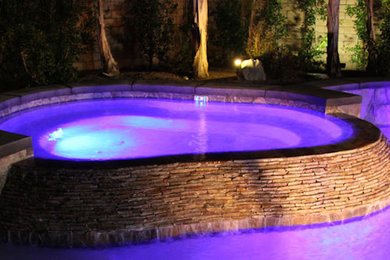 Example of a mid-sized trendy backyard lap hot tub design in Austin