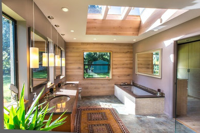 Inspiration for a large contemporary master beige tile and stone tile porcelain tile walk-in shower remodel in Tampa with an undermount sink, flat-panel cabinets, medium tone wood cabinets, solid surface countertops, an undermount tub, a one-piece toilet and purple walls