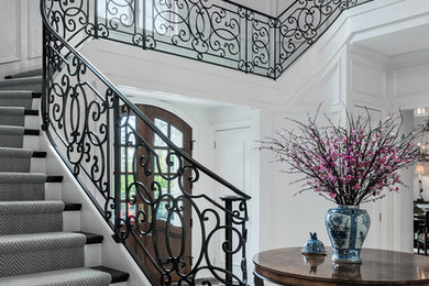 Design ideas for a large traditional wood curved staircase in Philadelphia with painted wood risers.
