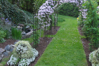 Design ideas for a mid-sized traditional full sun backyard stone landscaping in Boston.