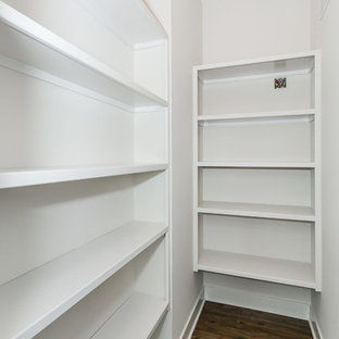 Mid-sized modern kitchen pantry appliance - Example of a mid-sized minimalist l-shaped light wood floor kitchen pantry design in Wichita with white cabinets, granite countertops, white backsplash and an island