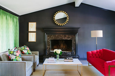 Transitional living room with black walls and a stone fireplace surround.