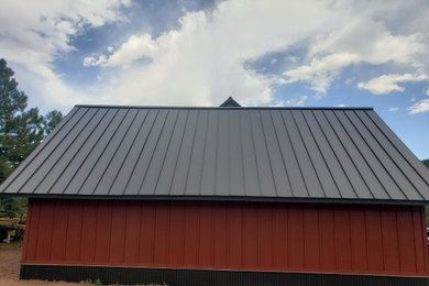 Example of a large classic white two-story wood exterior home design in Denver with a metal roof
