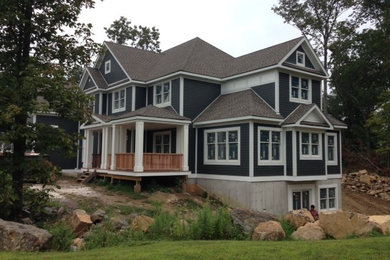 Large elegant blue two-story concrete fiberboard gable roof photo in New York