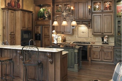 Open concept kitchen - mid-sized traditional l-shaped dark wood floor and brown floor open concept kitchen idea in Orlando with recessed-panel cabinets, dark wood cabinets, granite countertops, beige backsplash, ceramic backsplash, black appliances and an island