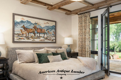 Photo of a country bedroom in Denver with exposed beam.