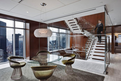 Huge minimalist marble floating mixed material railing staircase photo in New York with glass risers