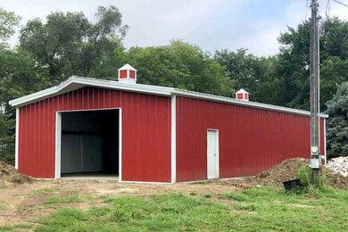 Garage workshop - large farmhouse detached four-car garage workshop idea in Other
