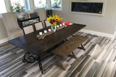 Huge mountain style porcelain tile and gray floor dining room photo in Sacramento with green walls, a two-sided fireplace and a stone fireplace