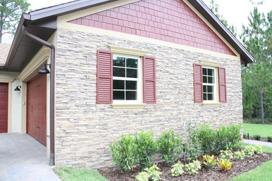 Inspiration for a large craftsman beige two-story stucco gable roof remodel in Orlando