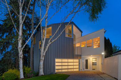 Photo of a large contemporary split-level exterior in Seattle with metal siding.